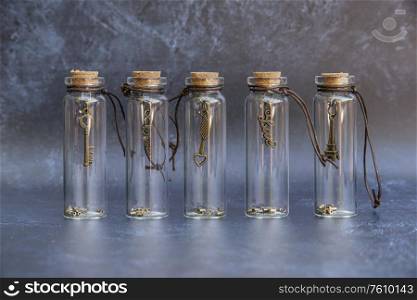 Romantic old vintage glass wish bottle with good luck charm inside bottle wth cork topper and antique effect background