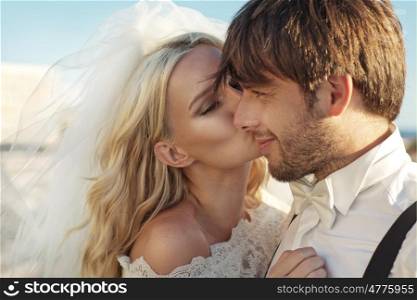 Romantic photo of young bride kissing her husband