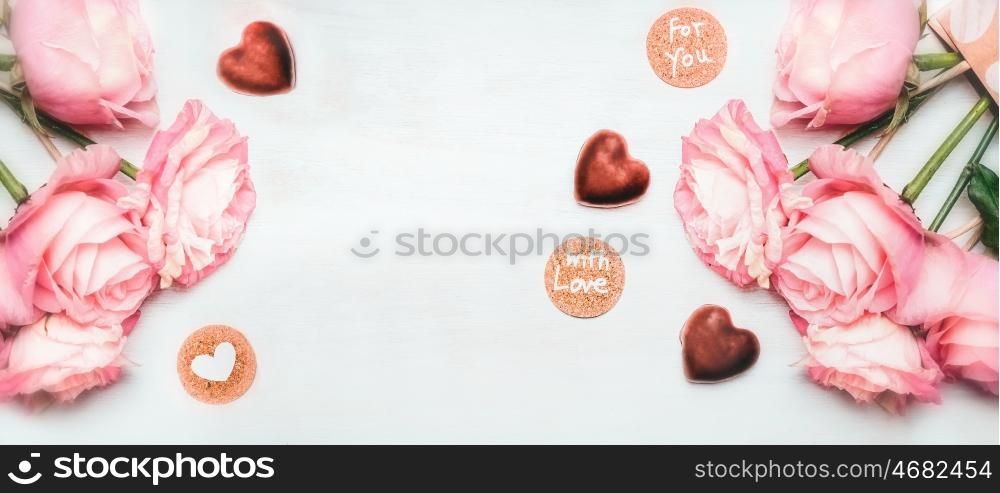 Romantic pink roses bunch with chocolate in shape of heart and cards with lettering with love for you on white wooden background, top view, banner