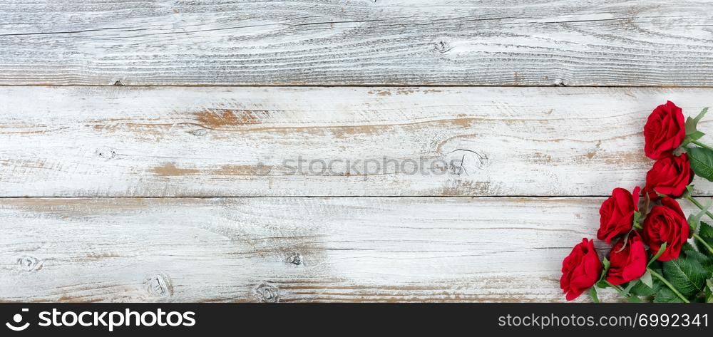 Romantic red roses on white rustic wooden background