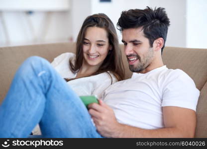 romantic relaxed young couple at modern home using tablet computer