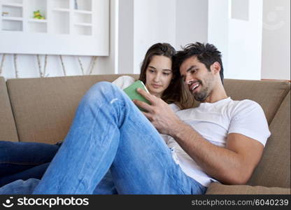 romantic relaxed young couple at modern home using tablet computer