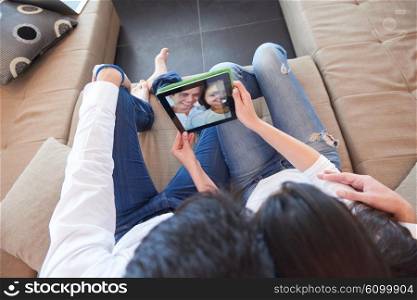 romantic relaxed young couple at modern home using tablet computer