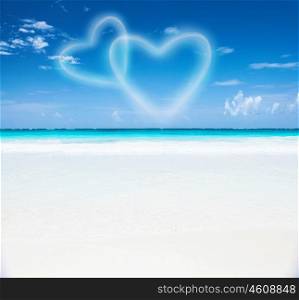 Romantic seaside resort, beautiful seascape, two heart shaped clouds in the blue sky, honeymoon vacation, paradise beach, summer holiday concept