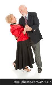 Romantic senior couple dancing together. He&rsquo;s dipping his beautiful wife. Full body isolated.