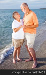 Romantic senior couple on a seaside vacation at the beach.