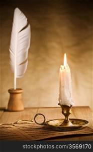 Romantic still-life with burning candle and music sheet