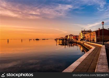 Romantic sunset on the Venice lagoon. Island of Pellestrina.. Romantic sunset on the Venice lagoon. Island of Pellestrina and town.