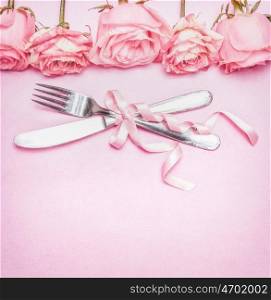 Romantic table place setting with pink roses flowers, cutlery and ribbon. Wedding, invitation , date or greeting card , top view