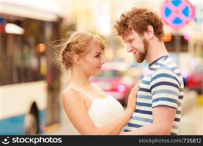 Romantic tourists couple walking in city street. Happy woman and man enjoying life summer vacation outdoor