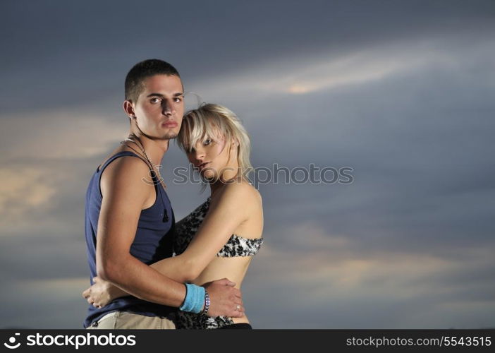 romantic urban couple dancing on top of the bulding at night scene