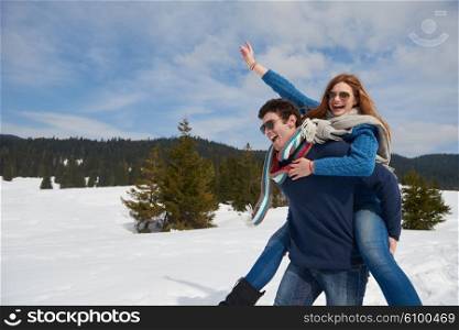 romantic winter scene, happy young couple having fun on fresh show on winter vacatio, mountain nature landscape