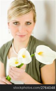Romantic woman hold calla lily flower on white purity femininity