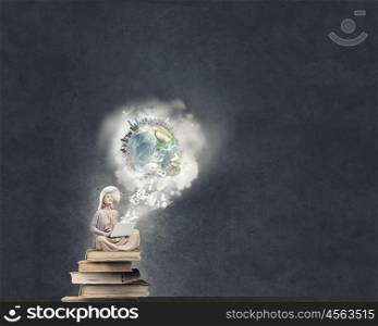 Romantic woman using laptop. Woman in dress and hat sitting on books and working on laptop. Elements of this image are furnished by NASA