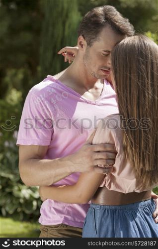 Romantic young couple embracing in park