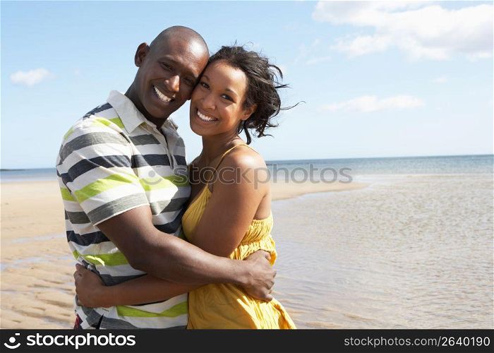 Romantic Young Couple Embracing On Beach