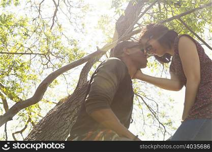 Romantic young couple face to face in tree