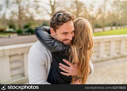 Romantic young couple hugging in Battersea Park, London, UK