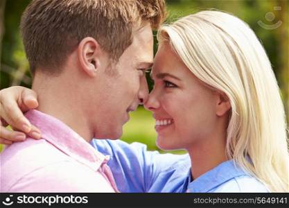 Romantic Young Couple Hugging In Garden