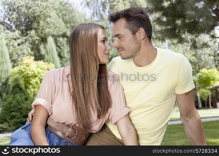 Romantic young couple looking at each other in park