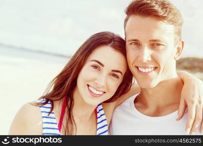 Romantic young couple on the beach. Portraits of romantic young couple on the beach