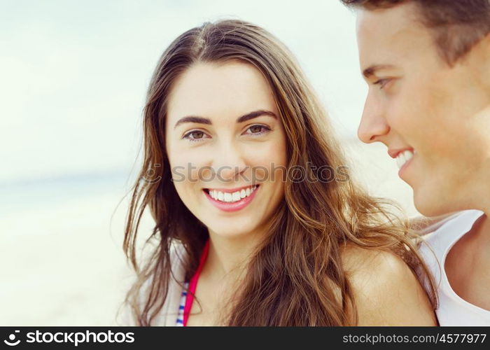 Romantic young couple on the beach. Portraits of romantic young couple on the beach