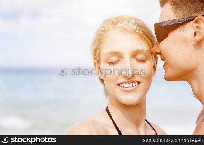 Romantic young couple on the beach. Portraits of romantic young couple on the beach