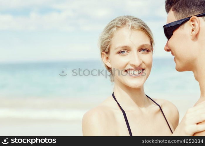 Romantic young couple on the beach. Portraits of romantic young couple on the beach