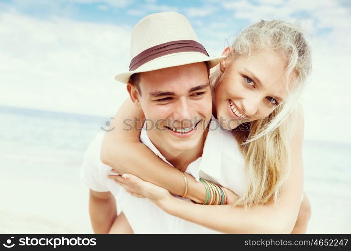 Romantic young couple on the beach. Portraits of romantic young couple on the beach