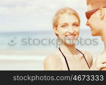 Romantic young couple on the beach. Portraits of romantic young couple on the beach