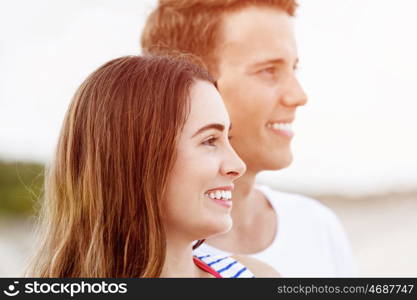 Romantic young couple on the beach. Portraits of romantic young couple on the beach