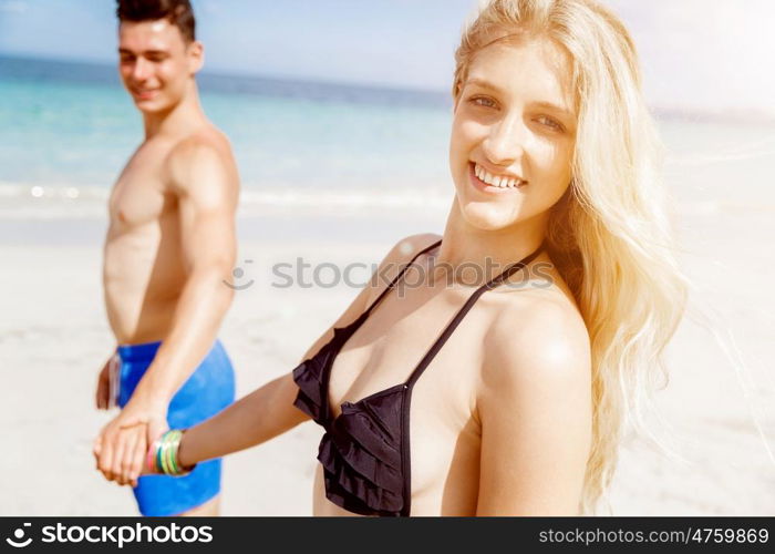 Romantic young couple on the beach. Portraits of romantic young couple on the beach