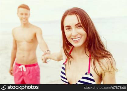 Romantic young couple on the beach. Portraits of romantic young couple on the beach