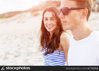 Romantic young couple on the beach. Portraits of romantic young couple on the beach