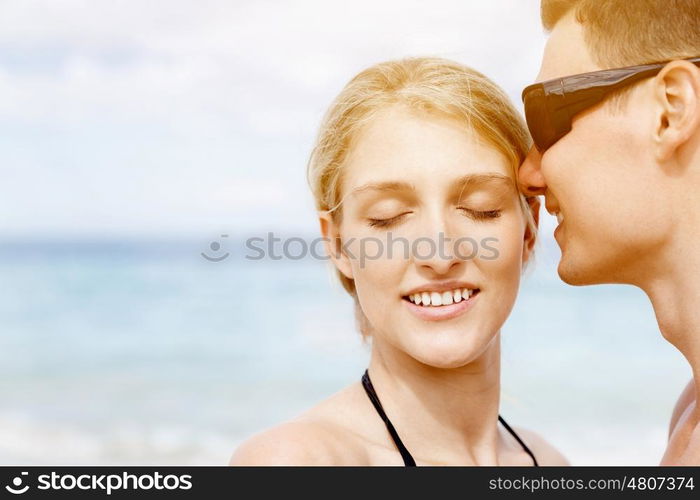 Romantic young couple on the beach. Portraits of romantic young couple on the beach