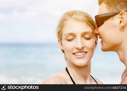 Romantic young couple on the beach. Portraits of romantic young couple on the beach