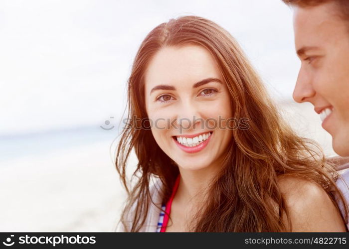 Romantic young couple on the beach. Portraits of romantic young couple on the beach