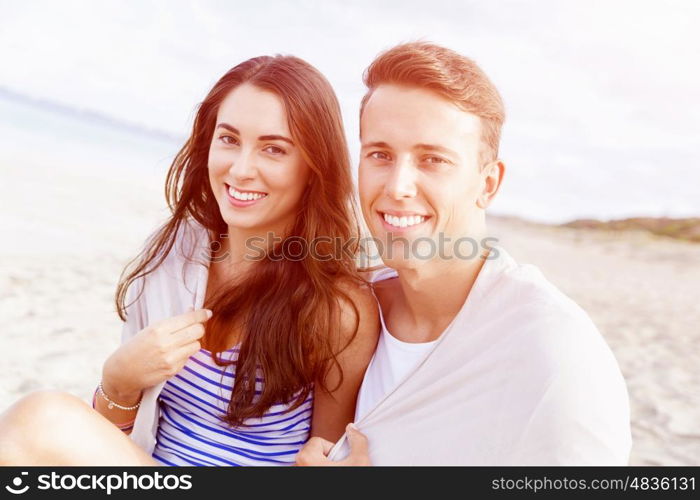 Romantic young couple on the beach. Portraits of romantic young couple on the beach