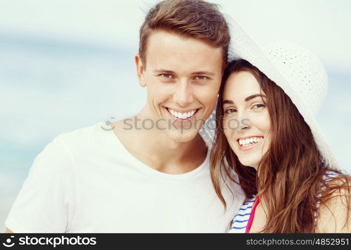 Romantic young couple on the beach. Portraits of romantic young couple on the beach