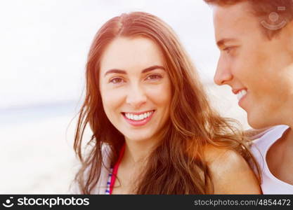 Romantic young couple on the beach. Portraits of romantic young couple on the beach