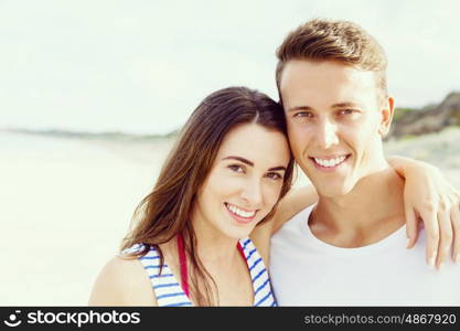 Romantic young couple on the beach. Portraits of romantic young couple on the beach