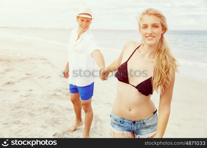 Romantic young couple on the beach. Portraits of romantic young couple on the beach