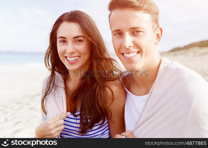 Romantic young couple on the beach. Portraits of romantic young couple on the beach