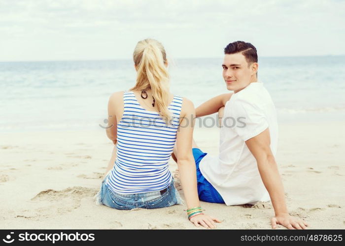 Romantic young couple on the beach. Portraits of romantic young couple on the beach