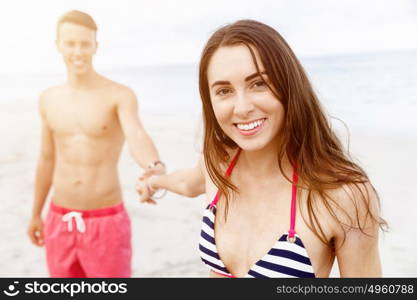 Romantic young couple on the beach. Portraits of romantic young couple on the beach