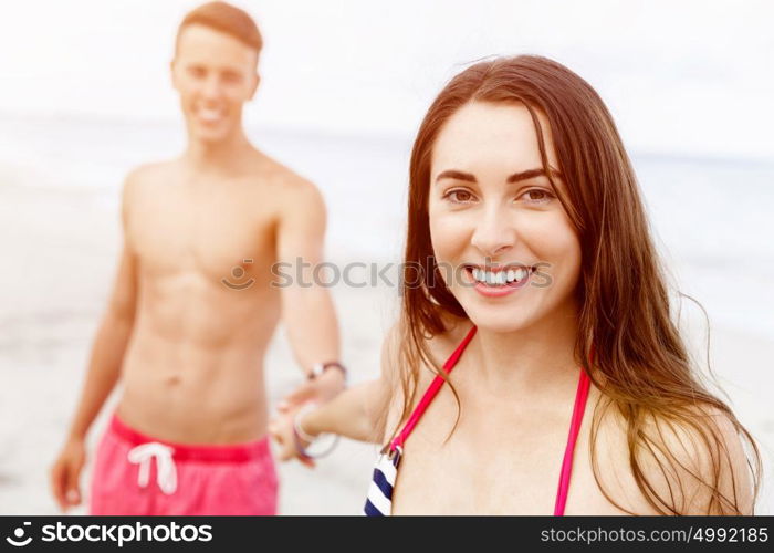 Romantic young couple on the beach. Portraits of romantic young couple on the beach