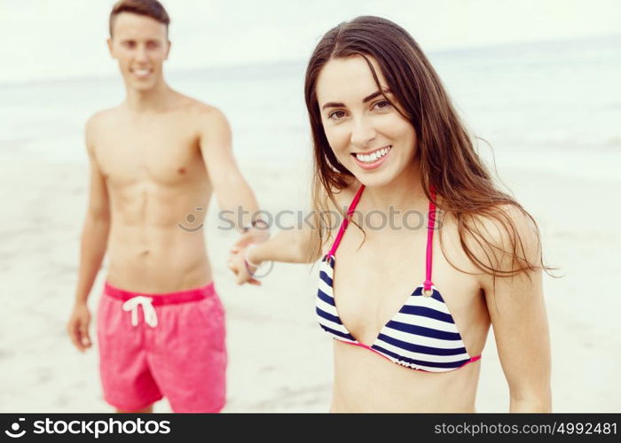 Romantic young couple on the beach. Portraits of romantic young couple on the beach