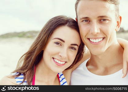 Romantic young couple on the beach. Portraits of romantic young couple on the beach