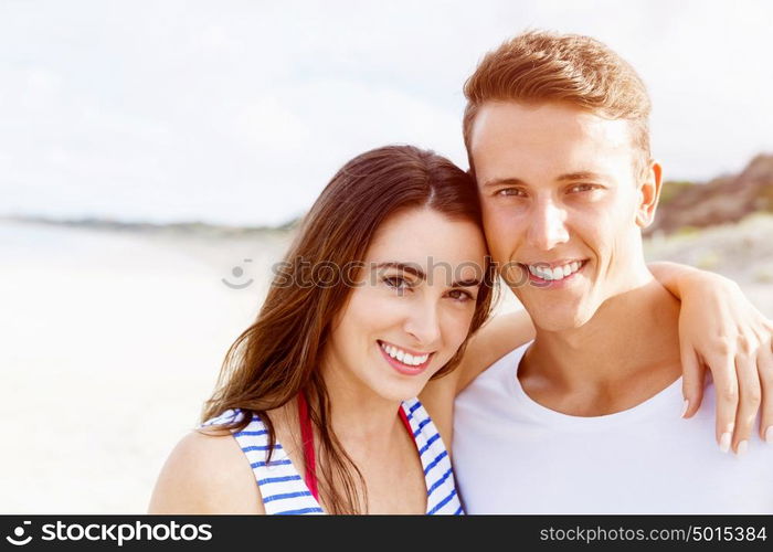 Romantic young couple on the beach. Portraits of romantic young couple on the beach