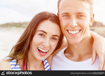 Romantic young couple on the beach. Portraits of romantic young couple on the beach